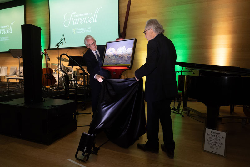 Renowned Canadian artist Phil Richards and USask President Peter Stoicheff are pictured beside the president’s official painted portrait. (Photo: David Stobbe)