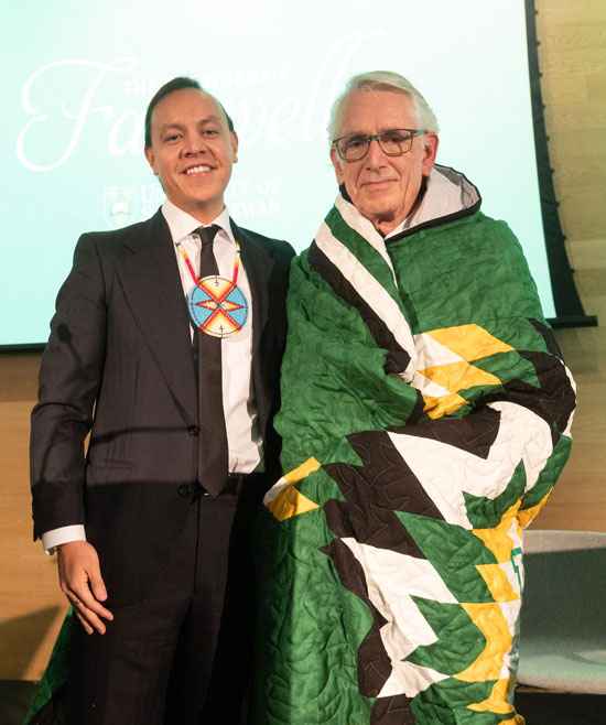 Renowned Canadian artist Phil Richards and USask President Peter Stoicheff are pictured beside the president’s official painted portrait. (Photo: David Stobbe)