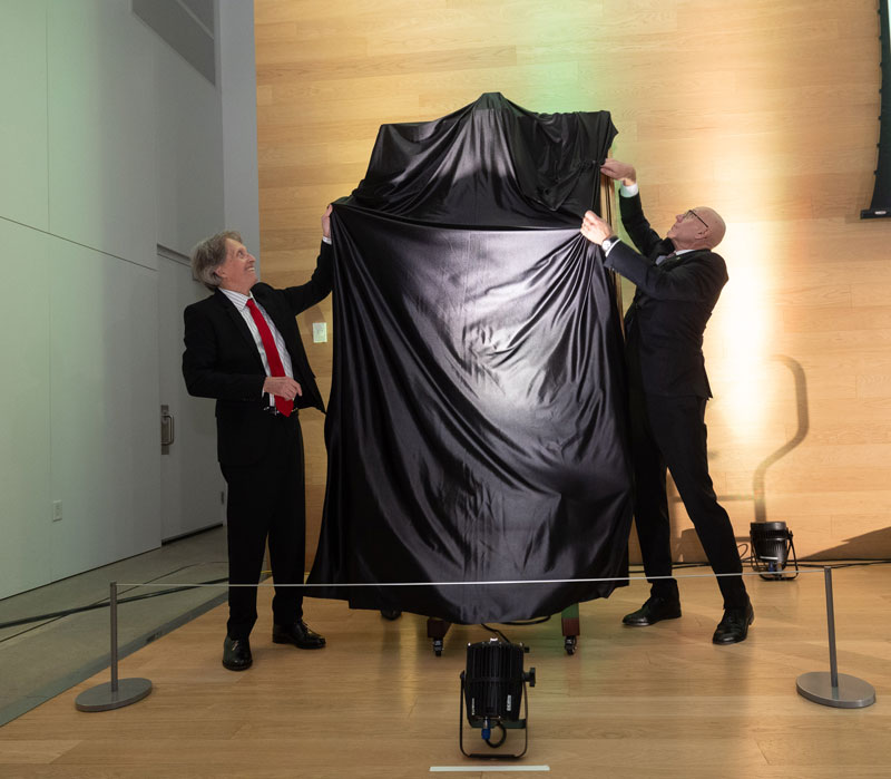 Renowned Canadian artist Phil Richards and USask President Peter Stoicheff are pictured beside the president’s official painted portrait. (Photo: David Stobbe)